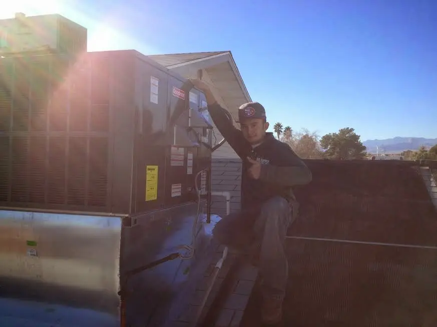 HVAC technician performing HVAC Inspection on a rooftop unit in Putnam